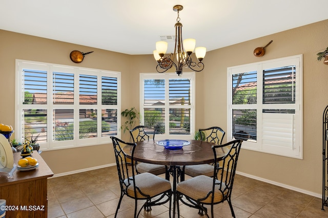 tiled dining area with an inviting chandelier and plenty of natural light