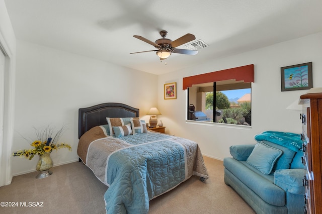 bedroom featuring light carpet, visible vents, and baseboards