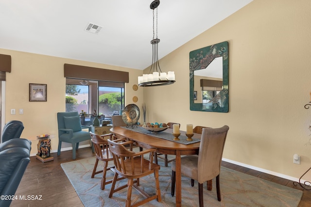 dining area with dark wood-style flooring, visible vents, vaulted ceiling, and baseboards