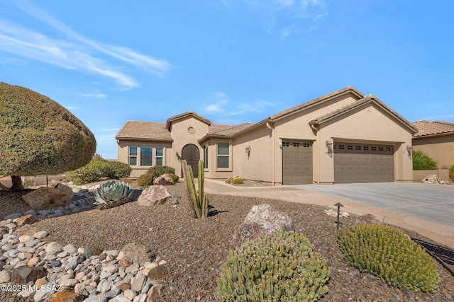 mediterranean / spanish home featuring a garage, driveway, a tiled roof, and stucco siding