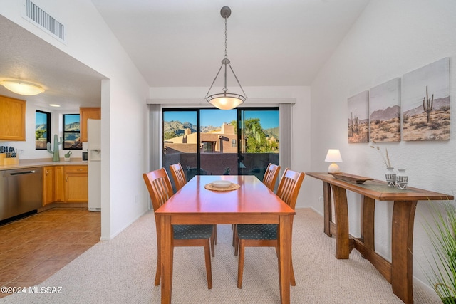 dining space featuring light colored carpet