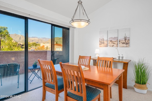 dining area featuring carpet flooring and a mountain view