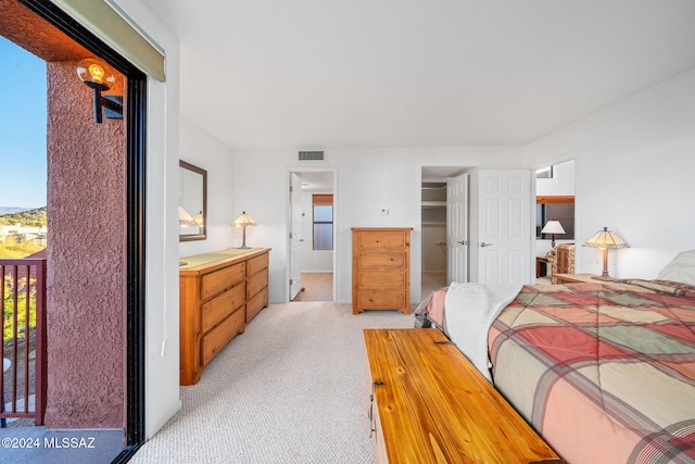 bedroom featuring light colored carpet and access to exterior