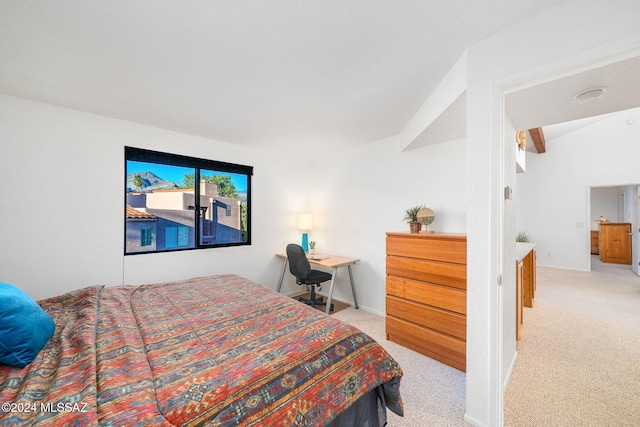 carpeted bedroom with vaulted ceiling