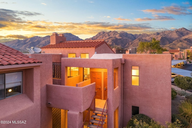 view of front of home featuring a mountain view and a balcony