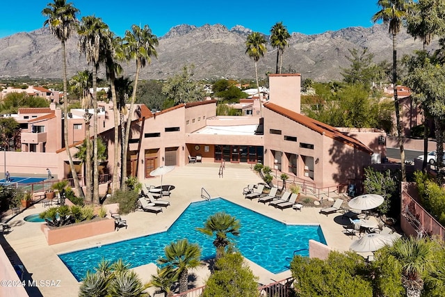 view of pool featuring a mountain view and a patio area