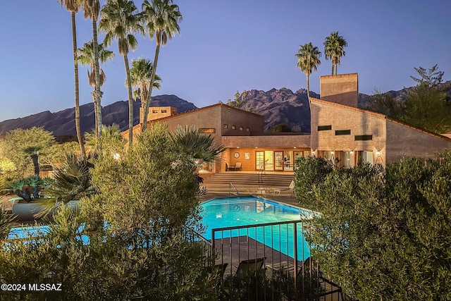 view of swimming pool with a mountain view and a patio area