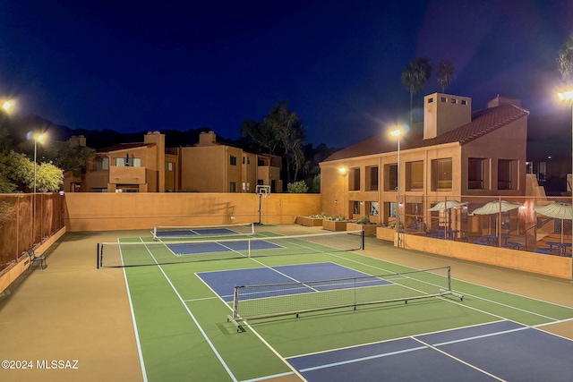 view of tennis court with basketball hoop