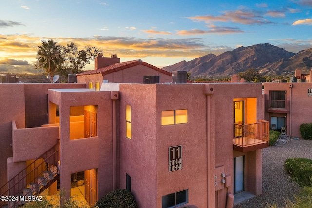 exterior space with a balcony and a mountain view