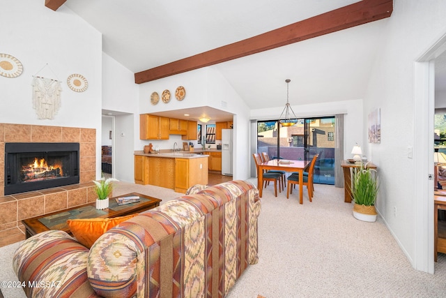 living room featuring light carpet, beam ceiling, a fireplace, and high vaulted ceiling