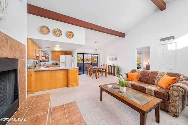 living room with high vaulted ceiling, beam ceiling, and light colored carpet