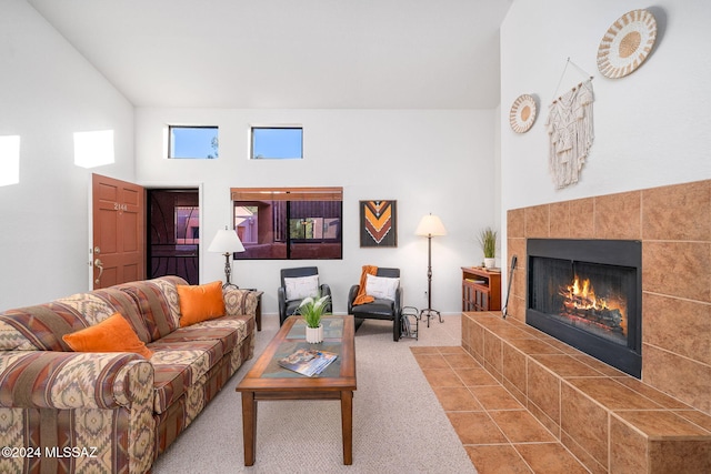 living room featuring light colored carpet and a tiled fireplace