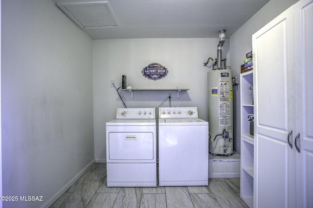 laundry area featuring baseboards, washing machine and clothes dryer, laundry area, gas water heater, and marble finish floor