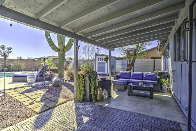 view of patio / terrace featuring an outdoor living space, a fenced in pool, a storage shed, a fenced backyard, and an outbuilding