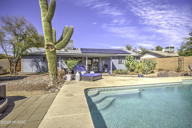 view of swimming pool featuring fence, a patio area, and a fenced in pool