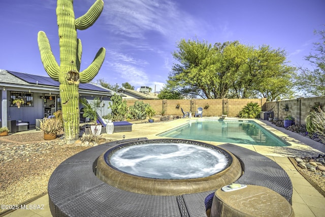 view of pool featuring a fenced in pool, a patio, an in ground hot tub, and a fenced backyard