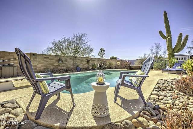 view of swimming pool featuring a patio area, a fenced in pool, and a fenced backyard