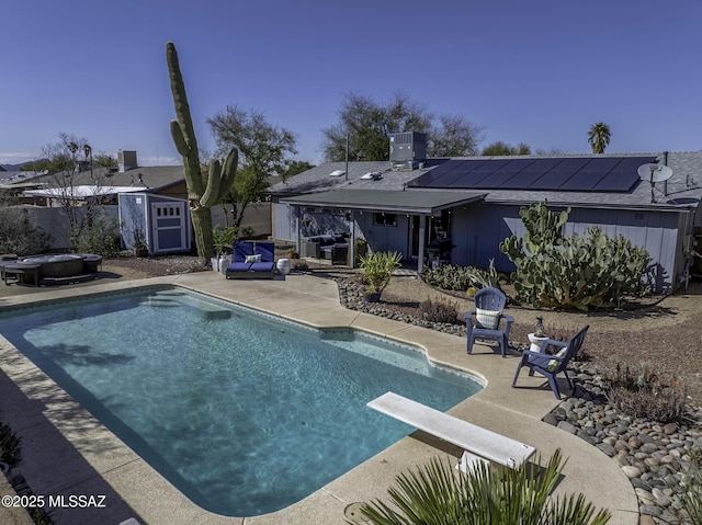 pool featuring central air condition unit, an outdoor structure, a patio, and a diving board