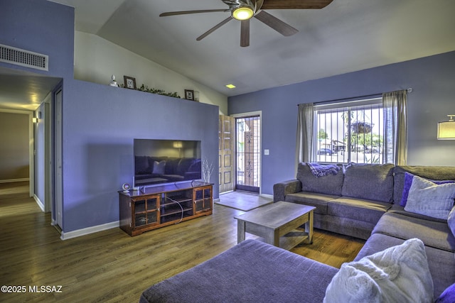 living room with visible vents, baseboards, lofted ceiling, and wood finished floors