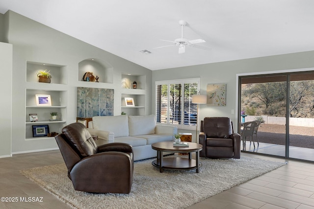 living room with ceiling fan, lofted ceiling, and built in features