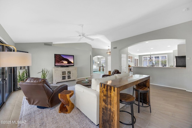 living room with vaulted ceiling and ceiling fan