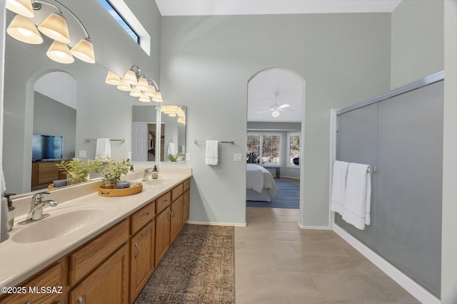 bathroom featuring vanity, a towering ceiling, and ceiling fan