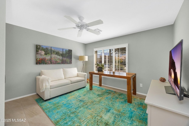 tiled living room featuring ceiling fan