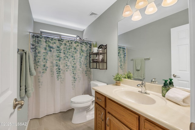 bathroom with a shower with curtain, vanity, toilet, and tile patterned flooring