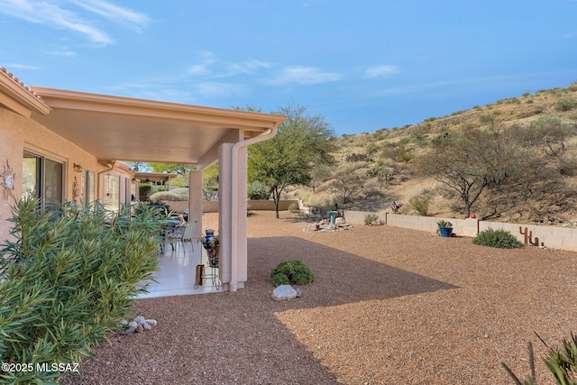 view of yard with a mountain view and a patio