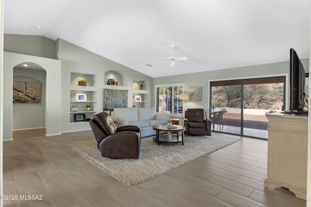 living room with vaulted ceiling, built in features, and ceiling fan