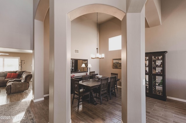 dining room with an inviting chandelier and a high ceiling