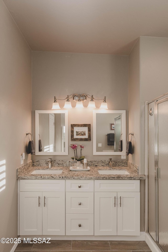 bathroom featuring vanity and an enclosed shower