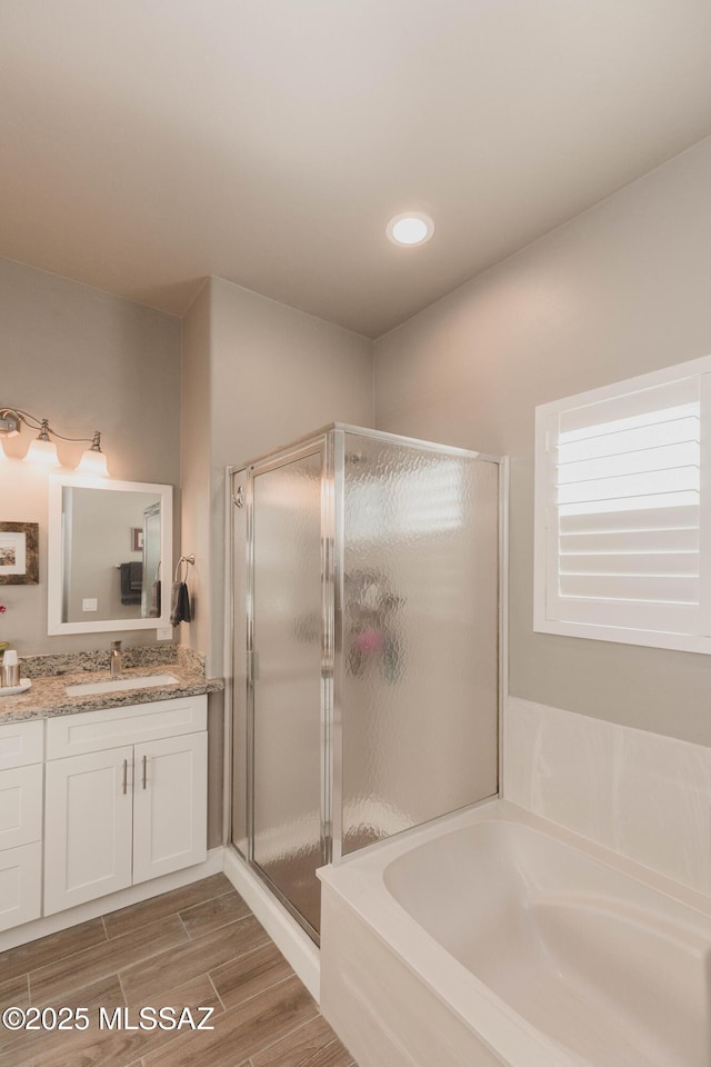 bathroom featuring vanity and plus walk in shower