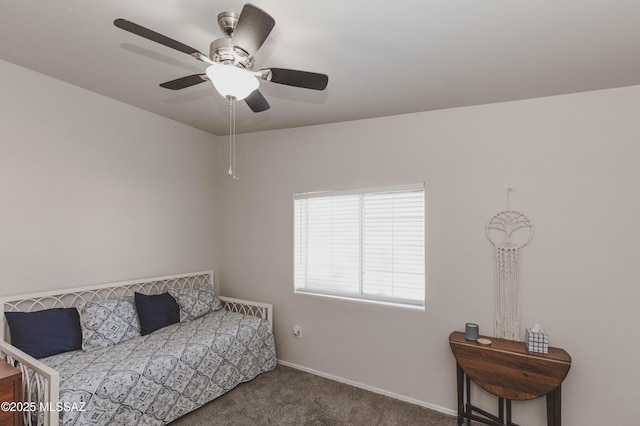 bedroom featuring ceiling fan and dark carpet