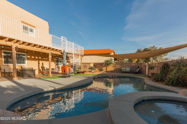 view of swimming pool with an in ground hot tub and a patio area