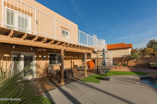 back of house with a balcony and a patio area