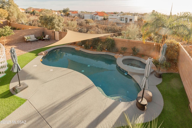 view of pool featuring a patio area and an in ground hot tub