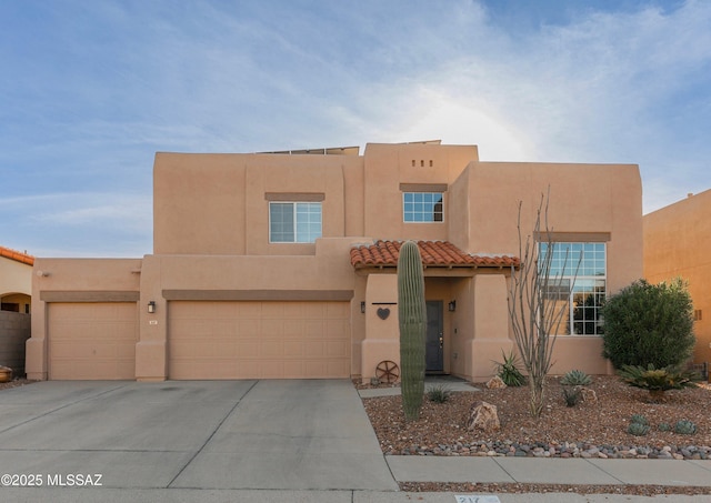 adobe home featuring a garage