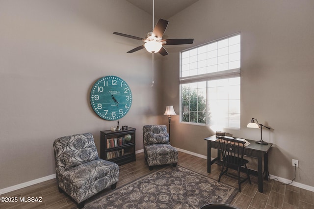 living area featuring lofted ceiling and ceiling fan