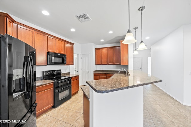 kitchen featuring hanging light fixtures, light tile patterned floors, black appliances, and kitchen peninsula