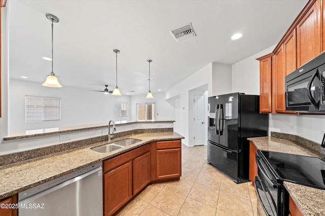 kitchen with stone countertops, sink, pendant lighting, and black appliances