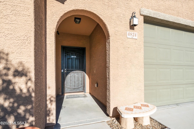 doorway to property featuring a garage