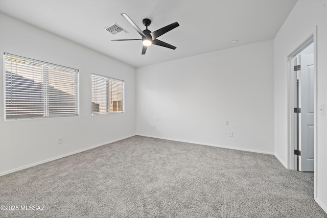 carpeted spare room with ceiling fan