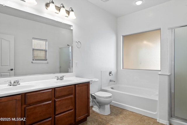 full bathroom featuring tile patterned flooring, vanity, shower with separate bathtub, and toilet