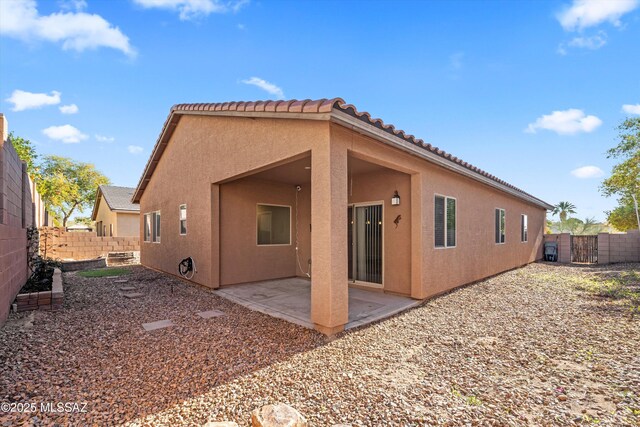 back of property with a patio