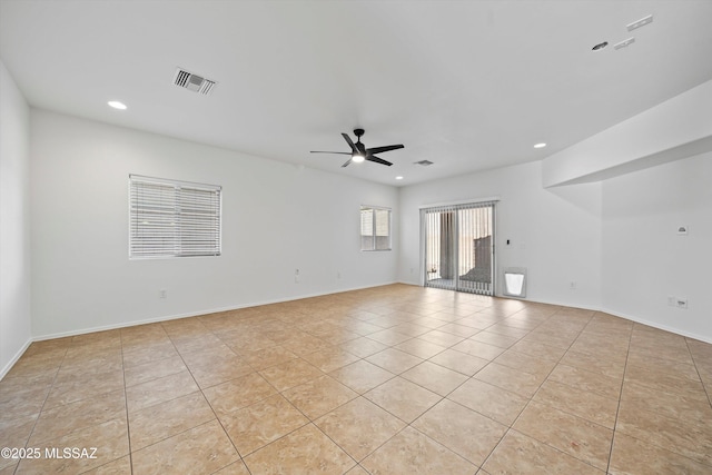 spare room featuring ceiling fan and light tile patterned floors