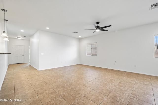 tiled empty room with ceiling fan