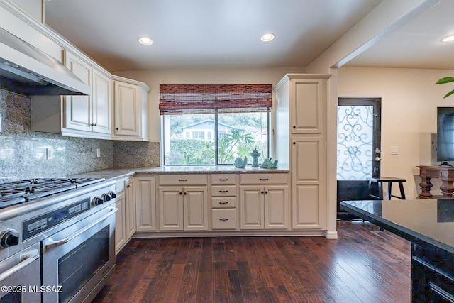 kitchen with dark wood-style floors, recessed lighting, decorative backsplash, stainless steel gas range, and exhaust hood