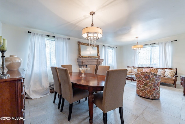 dining room with a chandelier, plenty of natural light, and light tile patterned flooring
