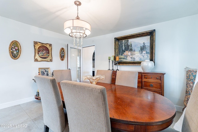 dining space with light tile patterned floors, baseboards, and a notable chandelier